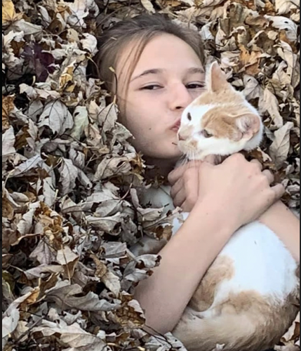 Girl and cat in leaves